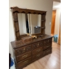 Image 10 : This vintage-style wooden dresser features ornate carved drawer fronts, brass-colored handles, and a