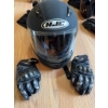 Image 6 : HJC full-face black motorcycle helmet with visor, a pair of Teknic armored gloves, and black leather