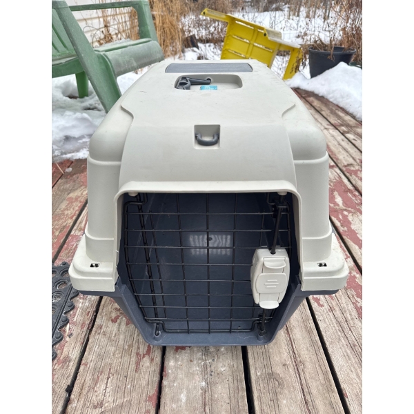 Pet carrier with lockable cage door, 15in wide, 16in tall and 26in deep.
