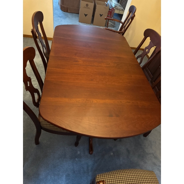  dining table set is a traditional style furniture piece featuring a rich  solid cherry  and elegant