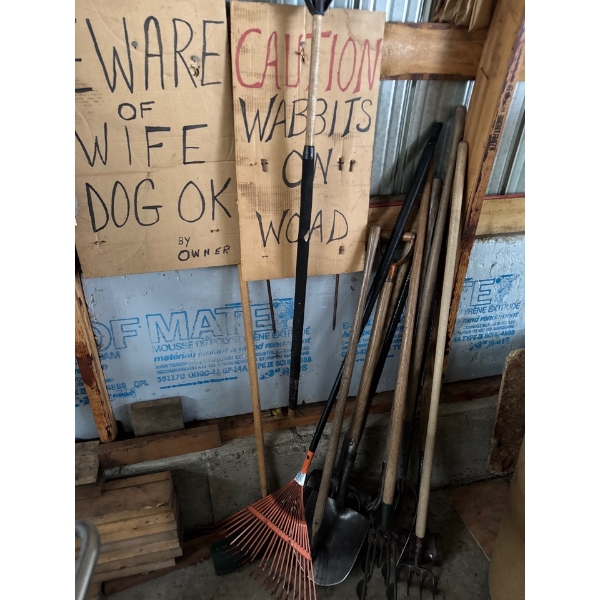 Pile of hand tools, including cardboard signs