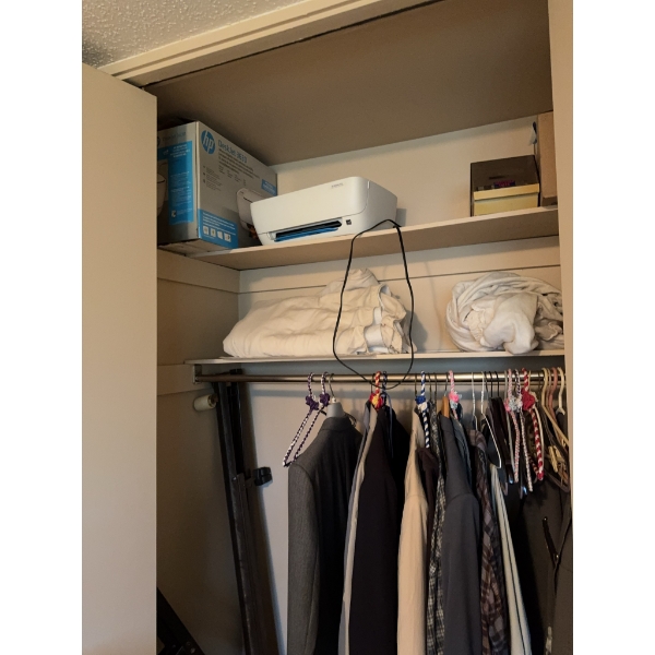 HP DeskJet 3752 wireless printer with original box, plus assorted clothing, hangers, and miscellaneo