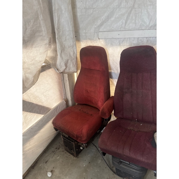 Two used burgundy cloth high-back air ride truck seats, likely compatible with various heavy-duty mo