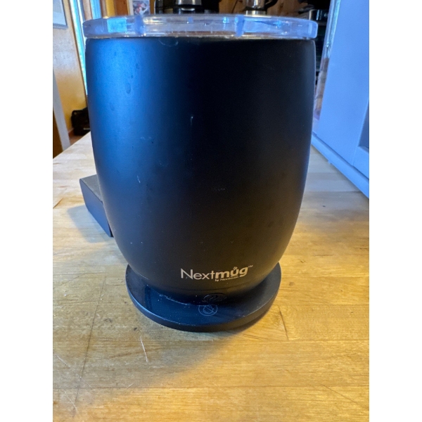 A Nextmug temperature controlled, self heating mug, it features a 14-ounce capacity and a black fini