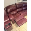 Image 1 : burgundy leather reclining sofa features a center console with built-in cup holders. 