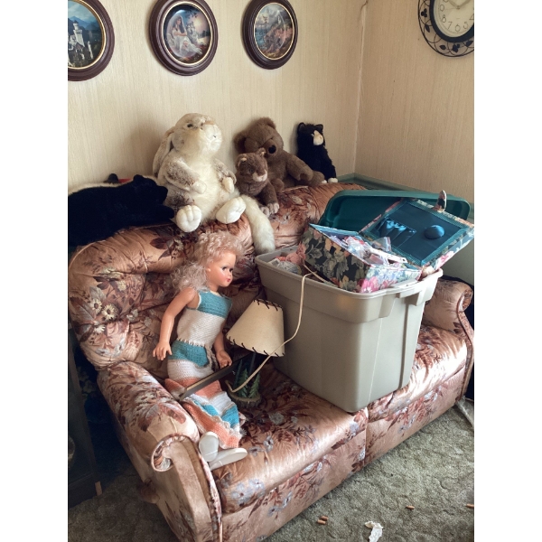 Vintage sofa, dolls, teddy bears. Bin full of yarn and sewing supplies. Three plates on the wall and