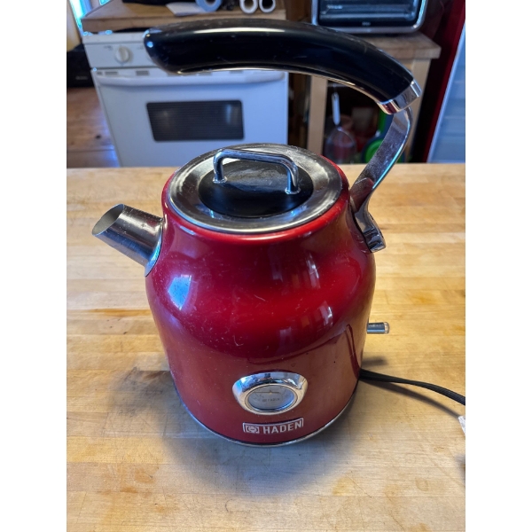 A Haden Dorset 1.7L stainless steel electric kettle in red. 1.7 Liters (approximately 7 cups). Inclu