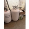 Image 1 : two 30 lb propane tanks, condition unknown, with a home and garden sprayer