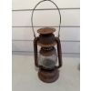 Image 1 : Beacon kerosene lantern made of metal with a clear glass globe and wire handle. Shows surface rust a