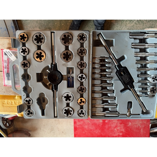 Tap and die set for threading, housed in a hard plastic carry case. Includes multiple dies, taps, ha