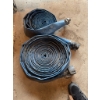 Image 1 : Lot consists of two blue layflat water hoses with attached metal couplings. The hoses are coiled and