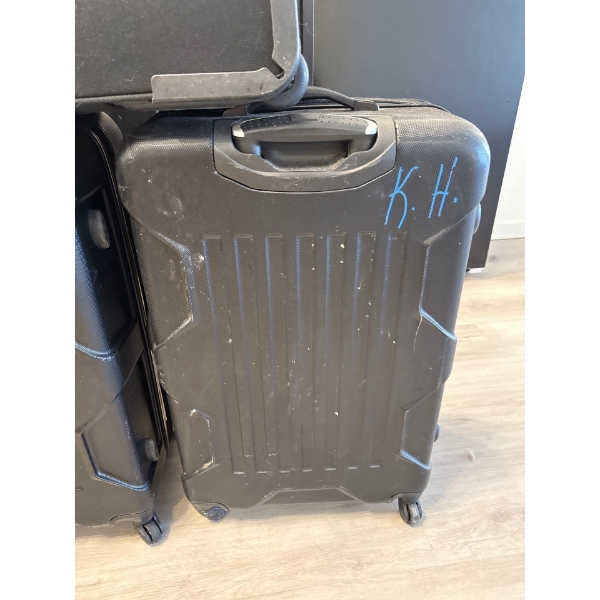 These are black Outbound hardside spinner suitcases, featuring a durable design and a built-in teles