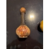 Image 5 : Decorative decanter featuring a ship illustration on the . The neck is wrapped in a dark material, 