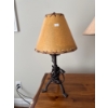 Image 2 : This is a rustic moose themed table lamp featuring a metal base and a faux leather or rawhide shade