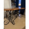 Image 1 :  wood-top console table with a black and gold wrought iron base. 
