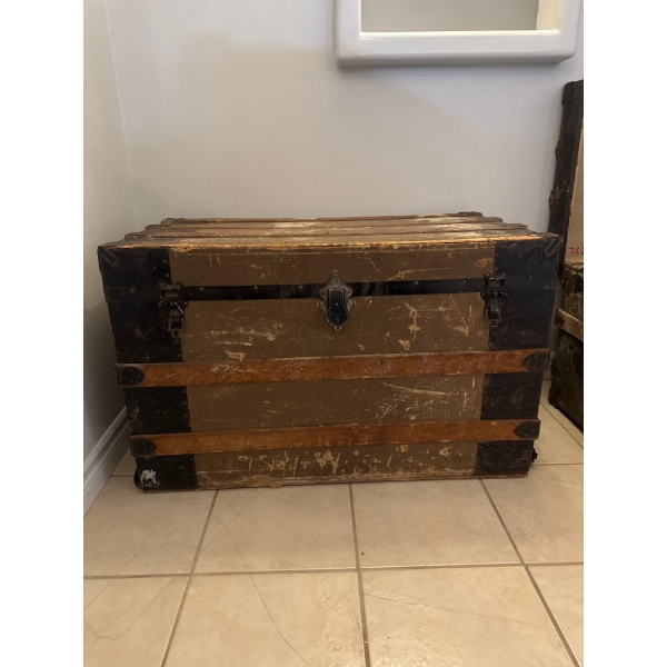 100 plus year old train vintage luggage trunk featuring reinforced latches, a worn exterior finish
