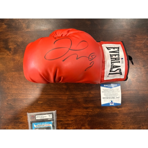  Red Everlast boxing glove autographed by a boxing legend, such as Floyd Mayweather Jr., Buster Doug
