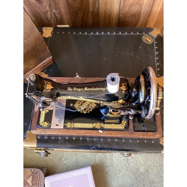 This is a vintage Singer sewing machine in a bentwood carrying case. , likely a Model 128 or similar