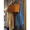 Image 1 :  vintage jacket, vintage shirt, and leather purse, and walking cane hanging on door.