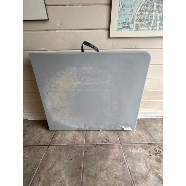 Six foot grey, portable folding utility, camping or versatile table from high-density polyethylene.