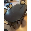 Image 8 : Dining set featuring an oval-shaped wooden table with dark finish and leaf extensions, accompanied b