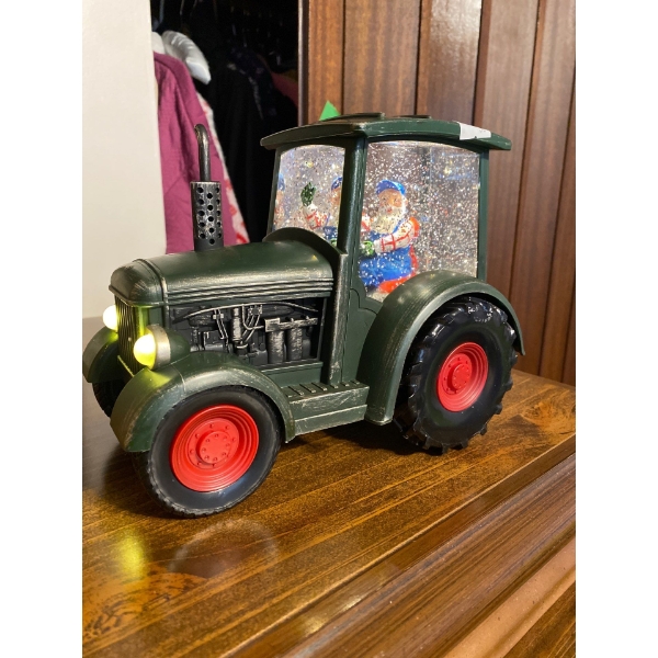 Santa snow globe in tractor