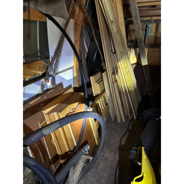 Wood boards, two by sixes, four by fours, tires, chicken wire, all items included in corner.