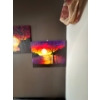 Image 2 : two acrylic paintings featuring vibrant sunset landscape scenes with trees and reflections on wate