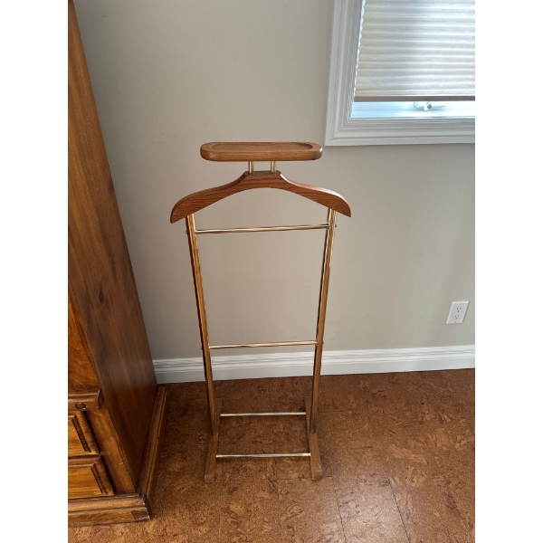  a vintage wooden and brass valet stand for organizing men's clothing and accessories.