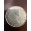 Image 2 : 1960 Canadian 50 cent coin featuring the coat of arms and a portrait of Queen Elizabeth II. The coin