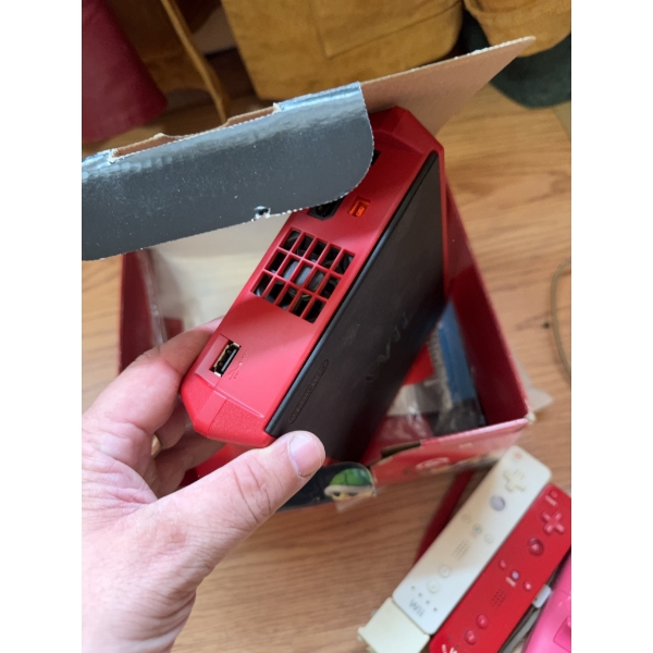 Nintendo Wii Mini console with original box and inserts, and a standard white Nintendo Wii console. 