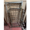 Image 1 : Vintage baby crib with a metal frame and spring mattress support. The crib is designed with a classi