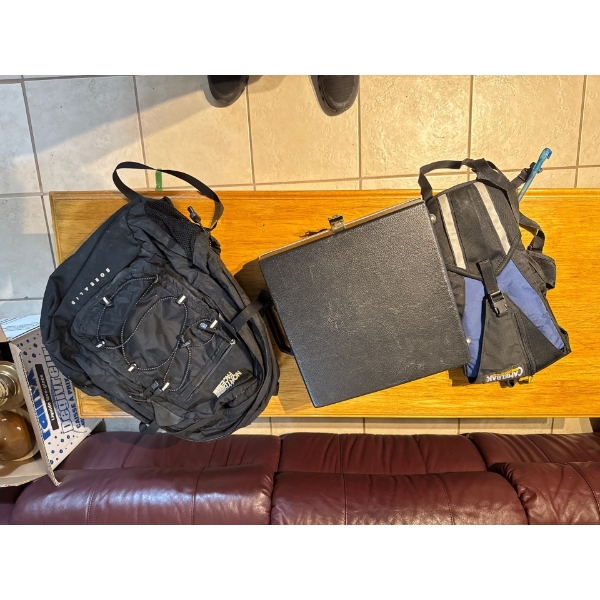 Couple of backpacks and suitcase, small suitcase.