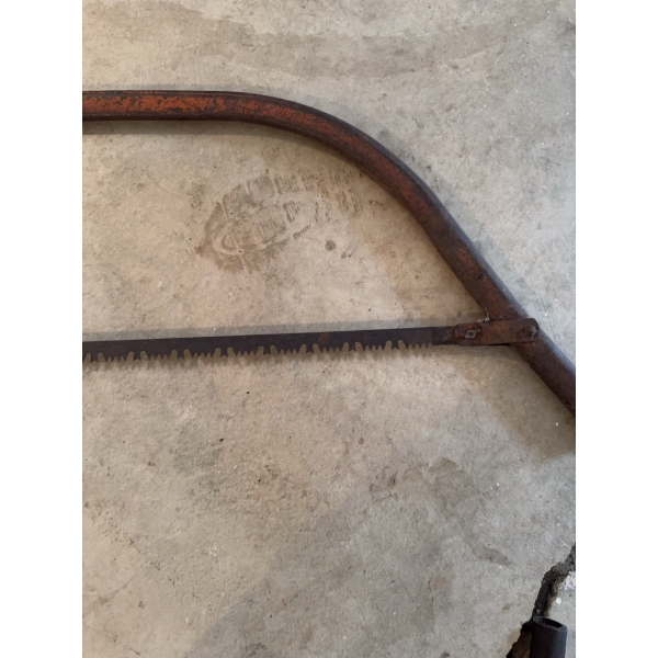 Steel bow saw featuring a curved frame and toothed blade, suitable for cutting wood. The frame displ