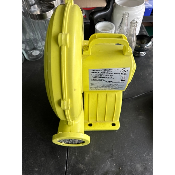 A yellow Super Electric S-3 air blower for inflatable bounce houses and toys