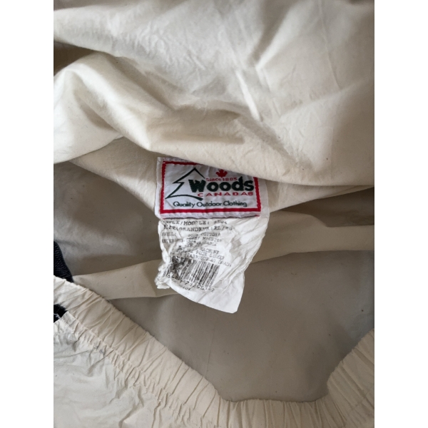 Woods Canada outdoor pullover jacket made from lightweight material in cream and black colors. Featu
