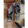 Image 1 : Adult snowshoes. One features a yellow frame with black deck, and the other a red frame with black d