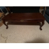 Image 1 : Rectangular wooden coffee table featuring a decorative brass-style drawer pull on the front and cabr