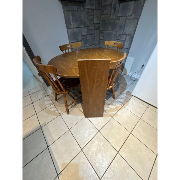  vintage dining set includes a round maple wood table matching spindle-back chairs. 