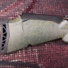Image 8 : Ruger American bolt-action rifle chambered in 7mm-08 Rem. Features a green speckled synthetic stock,