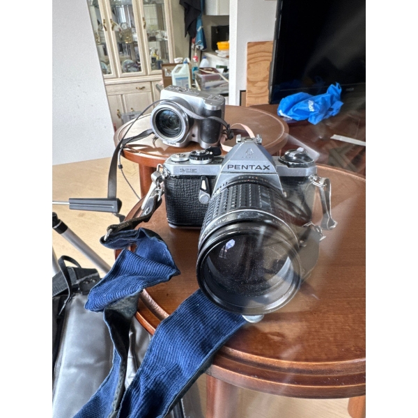  two wooden side tables, tripod, vintage camera gear.