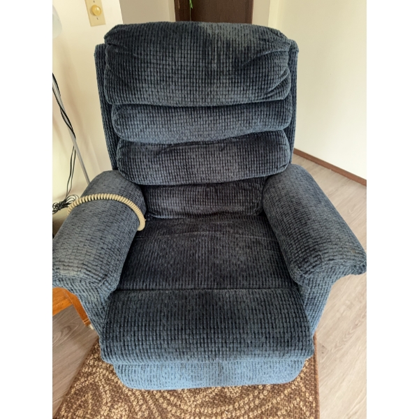 Blue recliner chair featuring corduroy upholstery and a padded, tufted backrest. Includes an attache