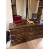 Image 14 : This vintage-style wooden dresser features ornate carved drawer fronts, brass-colored handles, and a