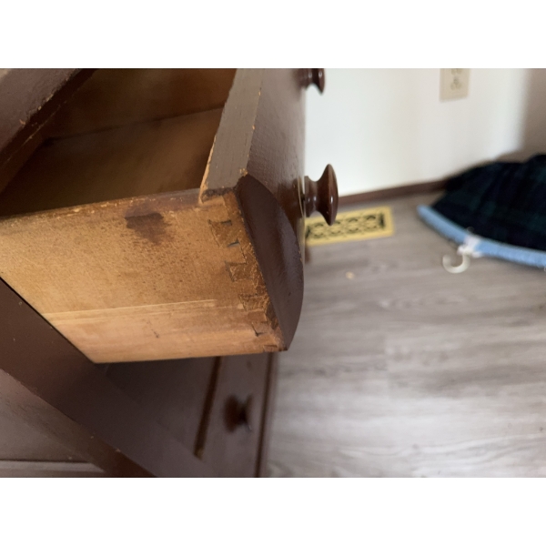 Wooden dresser with three drawers and attached oval mirror. Features dovetail joints on drawers and 