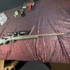 Image 2 : Ruger American bolt-action rifle chambered in 7mm-08 Rem. Features a green speckled synthetic stock,
