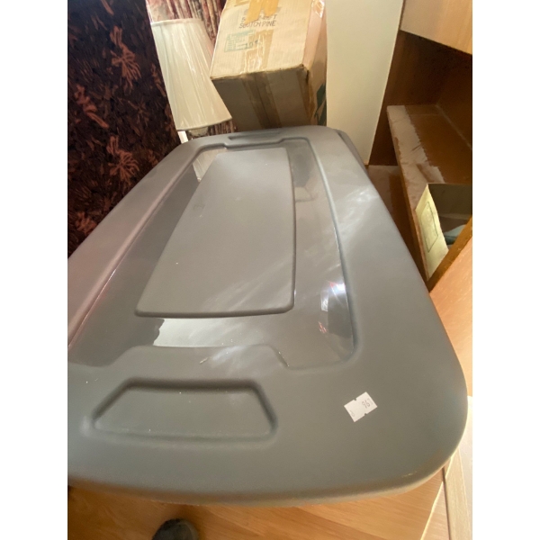 large Tupperware tote full of sewing supplies and fabric and Christmas tree