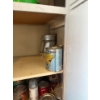 Image 5 : Miscellaneous items in the right cabinet of the laundry room, items include spray paint, pant, paint