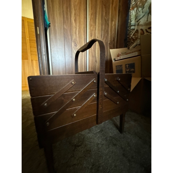 This is a vintage wood accordion-style sewing box. 
It is often made of solid wood with a rich finis