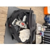 Image 2 : Travel bag with various items, power drill, and more.
