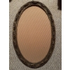 Image 4 : Oval metal frame with decorative floral design, containing a black and white photographic portrait o